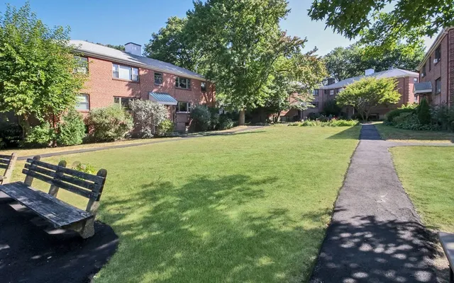 a view of a backyard with plants and a patio