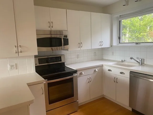 a kitchen with a sink stove and cabinets