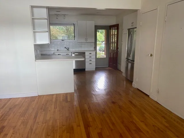 a view of a kitchen cabinets a sink and wooden floor
