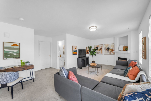 1147 West State Road Lehi, UT 84043 - Photo 13 of 31 Inviting living area featuring light gray carpeting, neutral wall colors, a built-in fireplace with a tiled surround, a recessed wall niche, and a flush mount ceiling light fixture