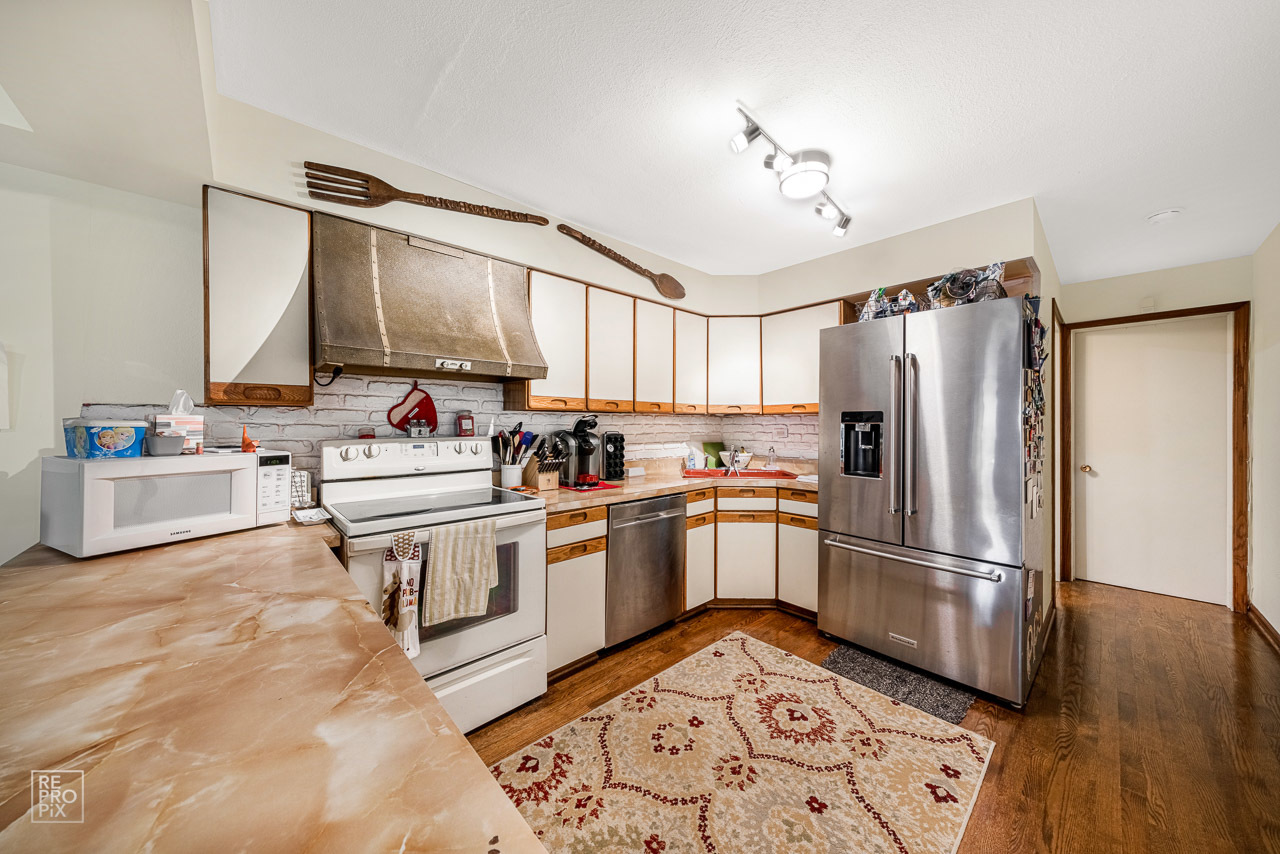 20 North Dee Road Park Ridge, IL 60068 - Photo 5 of 15 a kitchen with a refrigerator cabinets and wooden floor