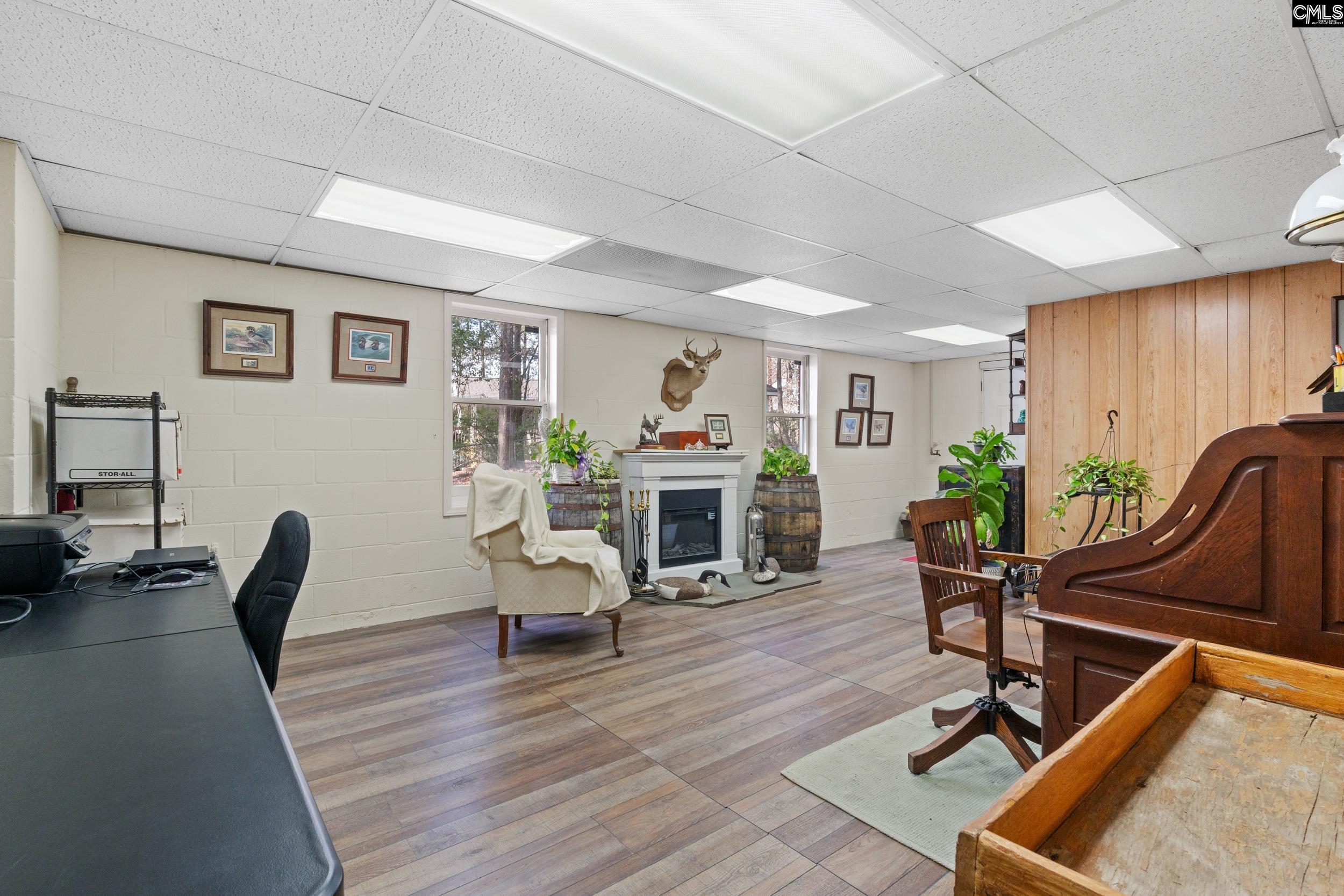 115 Rocky Ridge Road Leesville, SC 29070 - Photo 37 of 51 a living room with furniture a wooden floor and a fireplace