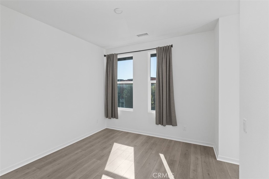 109 Mirth Irvine, CA 92618 - Photo 15 of 43 an empty room with wooden floor and windows