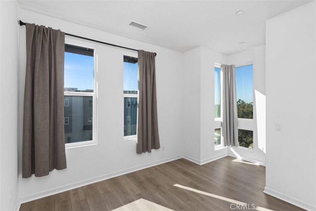 109 Mirth Irvine, CA 92618 - Photo 16 of 43 an empty room with wooden floor and windows
