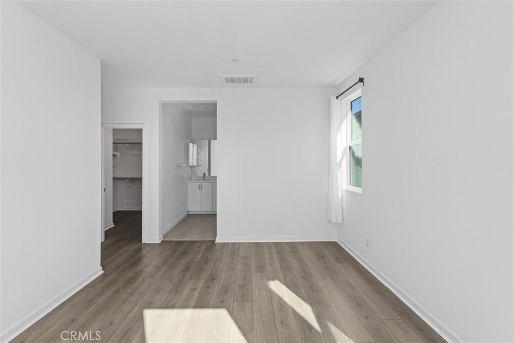 109 Mirth Irvine, CA 92618 - Photo 18 of 43 an empty room with wooden floor and a window