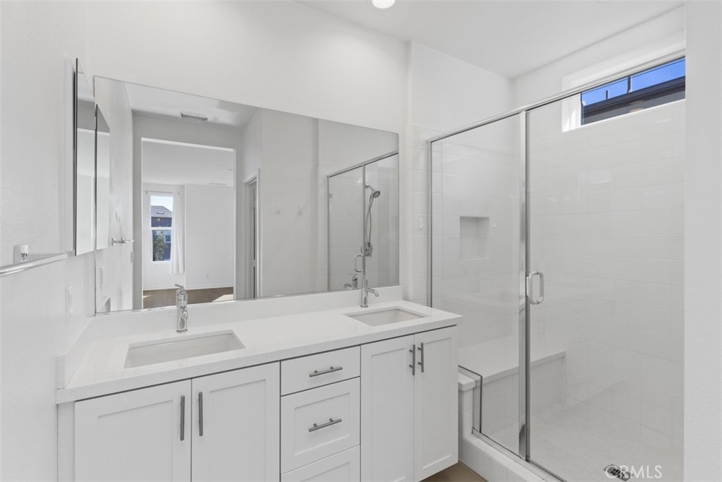 109 Mirth Irvine, CA 92618 - Photo 19 of 43 a bathroom with a shower sink vanity and mirror