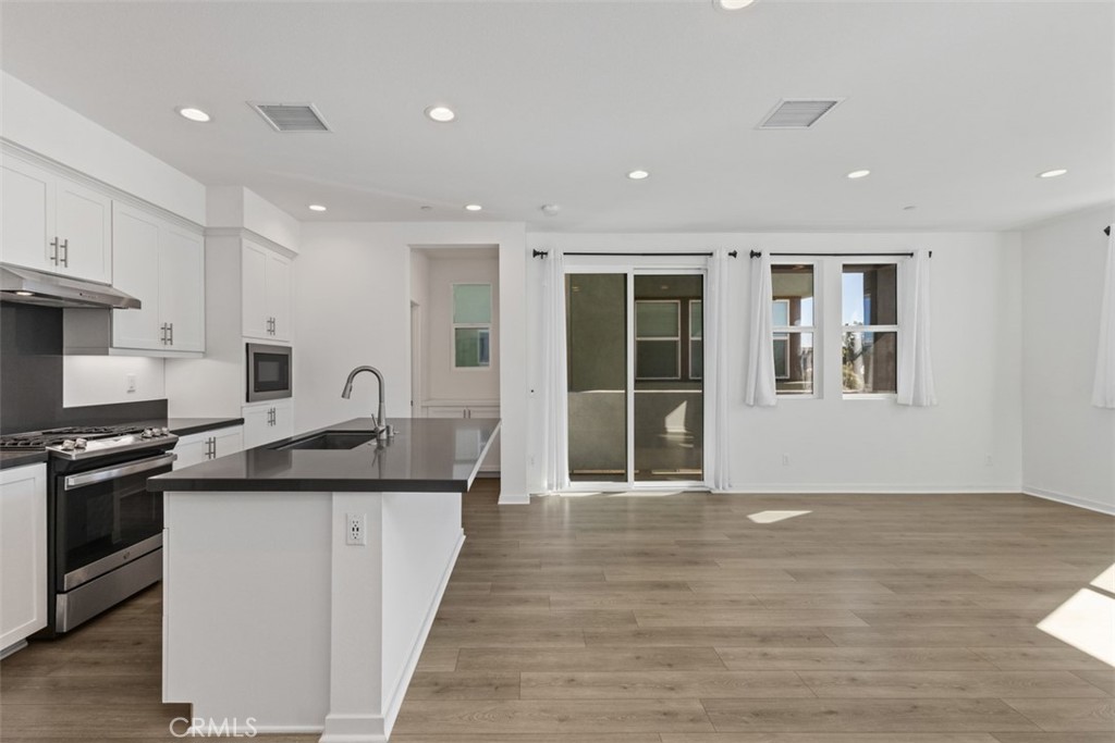 109 Mirth Irvine, CA 92618 - Photo 6 of 43 a kitchen with stainless steel appliances granite countertop a sink and a stove top oven