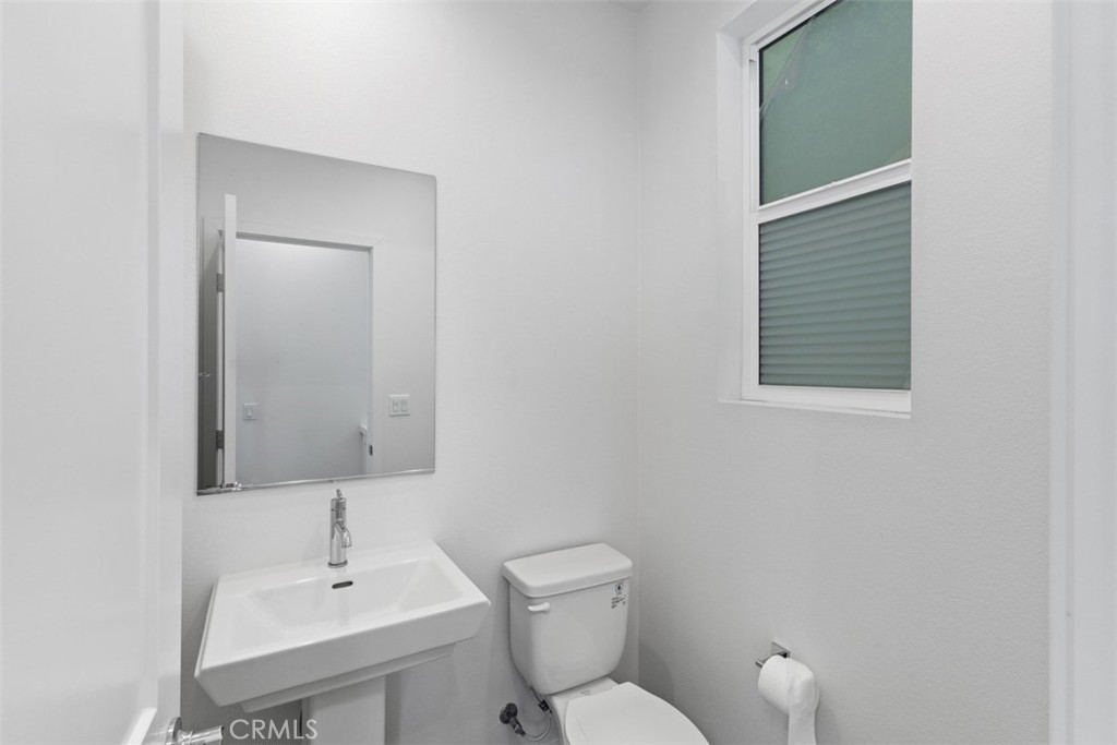 109 Mirth Irvine, CA 92618 - Photo 9 of 43 a bathroom with a toilet sink and mirror