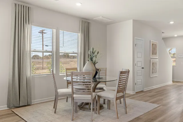 a view of a dining room with furniture window and wooden floor
