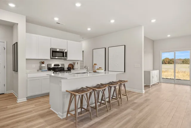 a spacious bedroom with a bed and a lamp