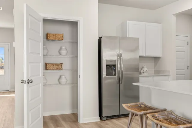 a bedroom with a bed and painting on the wall