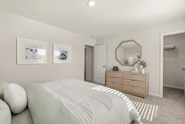 a large white bed in a white room