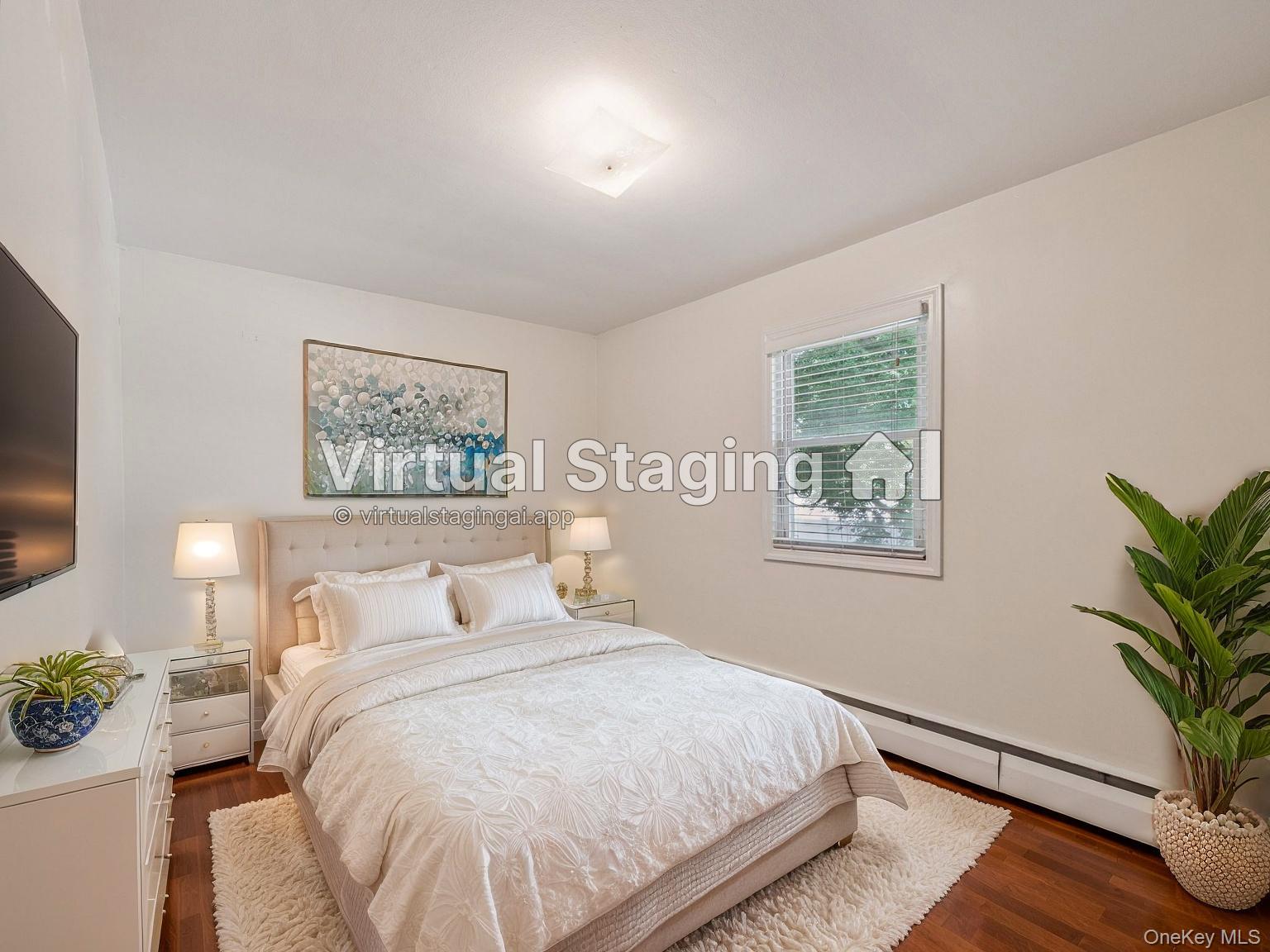 247 Woods Road North Babylon, NY 11703 - Photo 22 of 43 a bedroom with a large bed and a potted plant