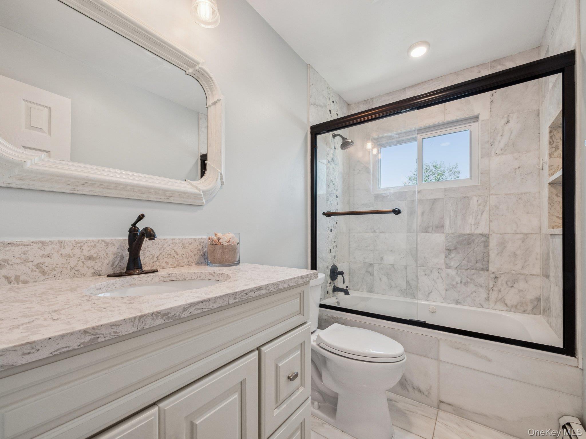 247 Woods Road North Babylon, NY 11703 - Photo 23 of 43 a bathroom with a granite countertop sink toilet and shower