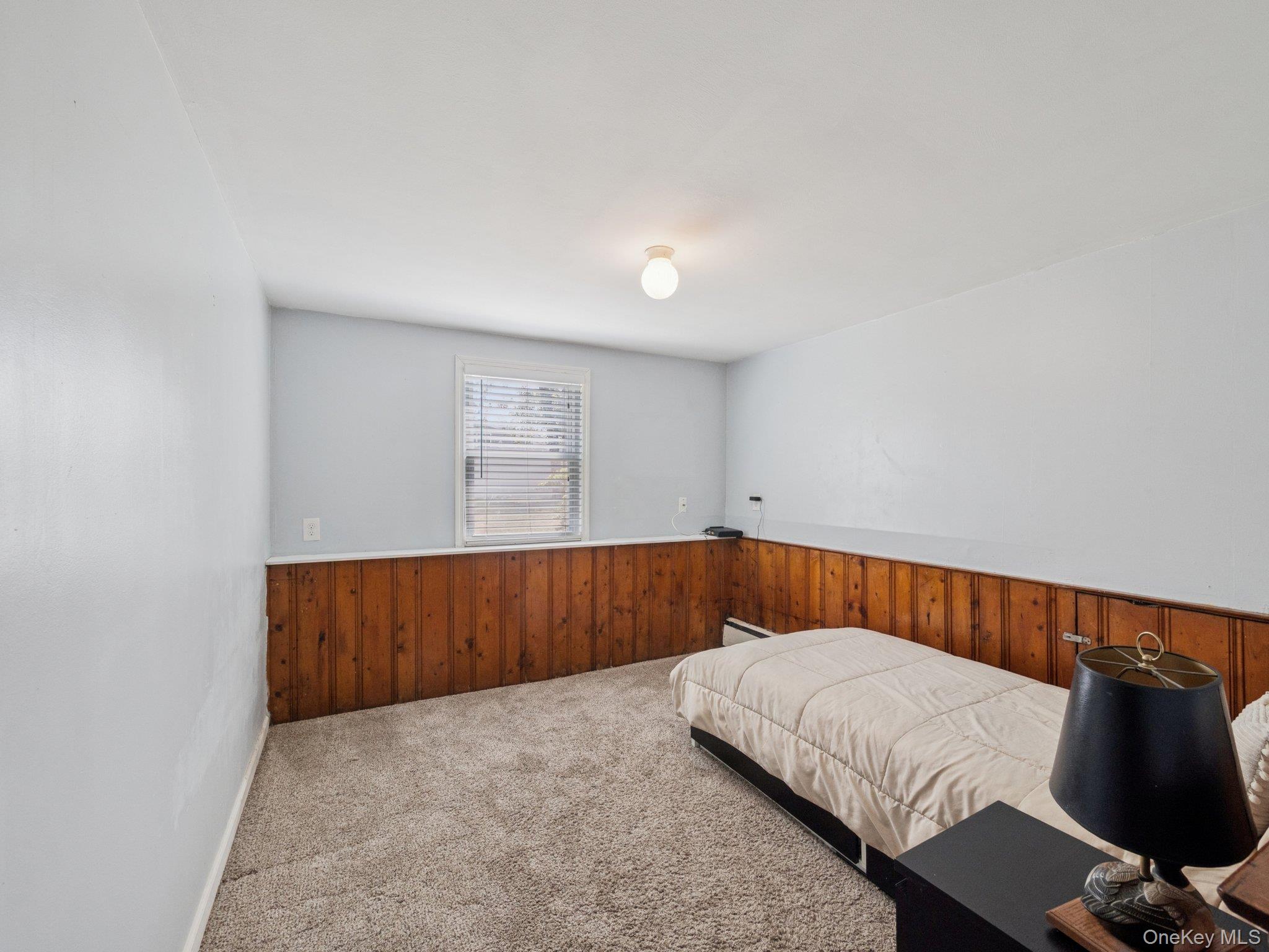 247 Woods Road North Babylon, NY 11703 - Photo 25 of 43 a bedroom with a bed and chair