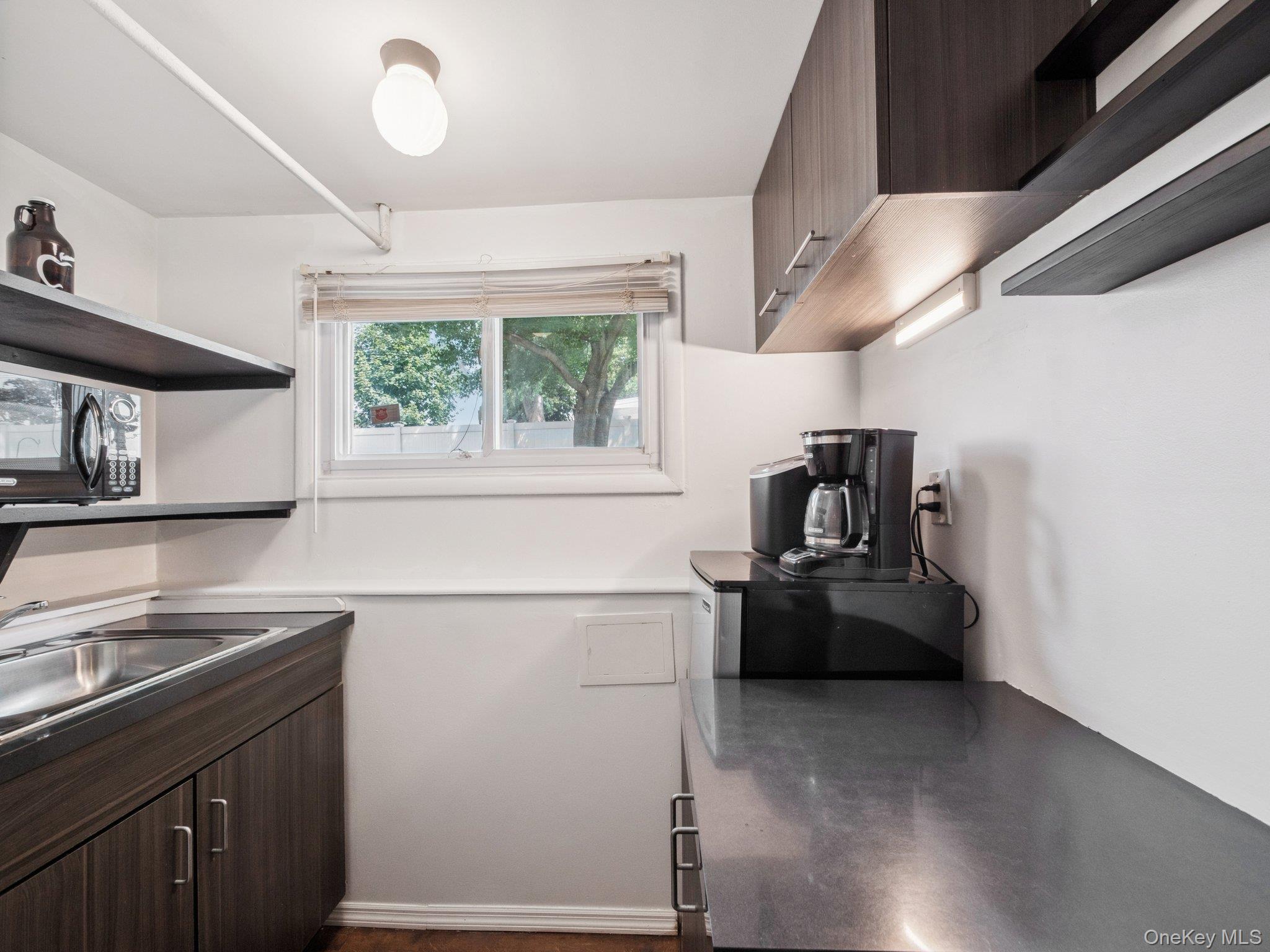 247 Woods Road North Babylon, NY 11703 - Photo 30 of 43 a kitchen with a sink cabinets and appliances