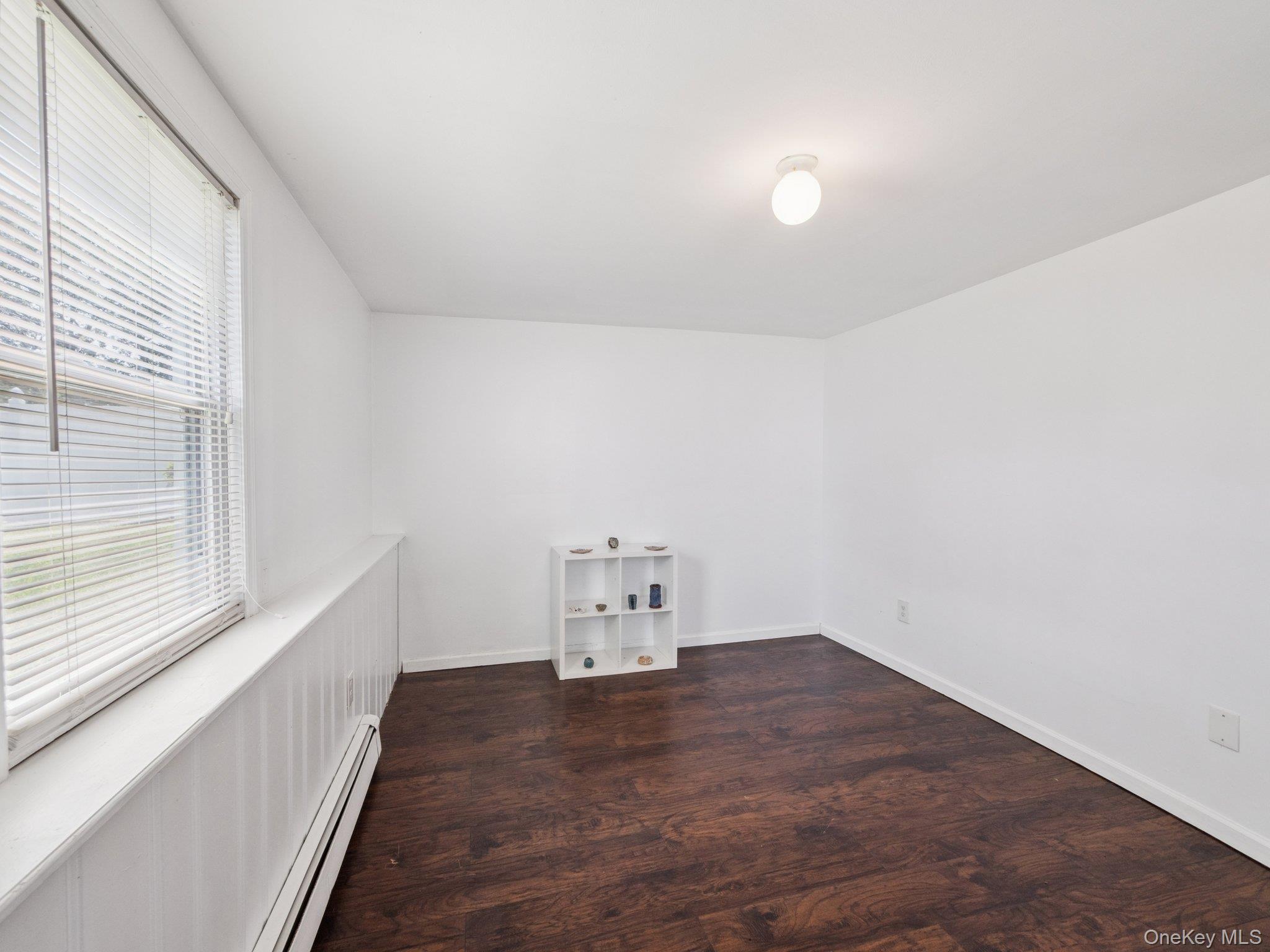 247 Woods Road North Babylon, NY 11703 - Photo 32 of 43 a view of room with stairs and a window