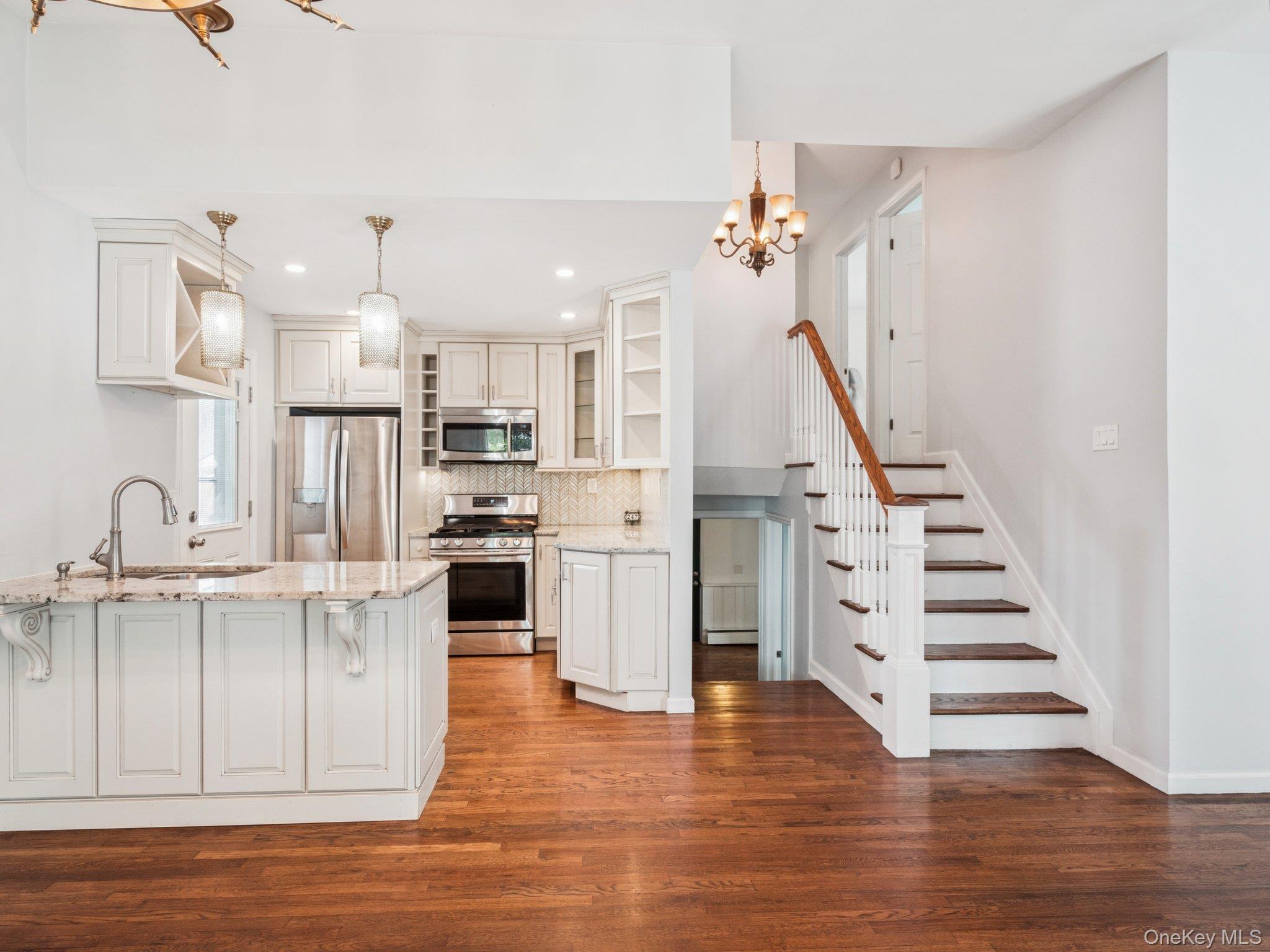 247 Woods Road North Babylon, NY 11703 - Photo 4 of 43 a view of kitchen with wooden floor and electronic appliances