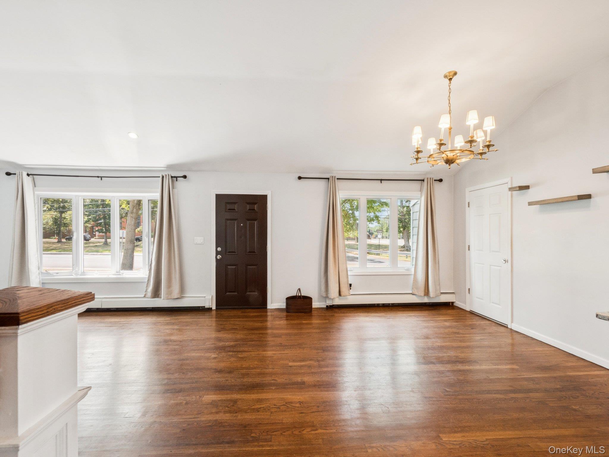 247 Woods Road North Babylon, NY 11703 - Photo 5 of 43 a view of an empty room with wooden floor and a window