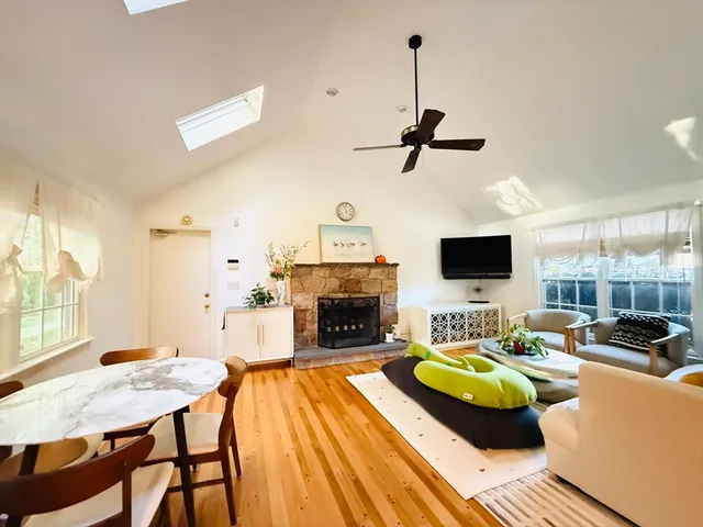 a living room with furniture a fireplace and a flat screen tv