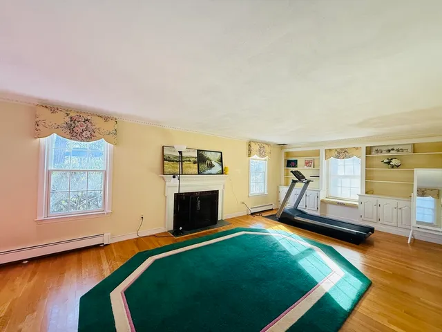 a spacious bedroom with a bed and wooden floor