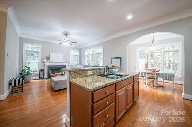 a kitchen with sink stove and dining table with chair