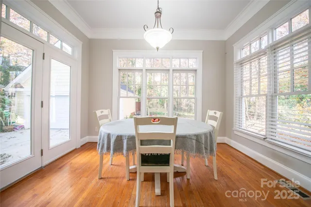 a view of a dining room with furniture wooden floor and a chandelier