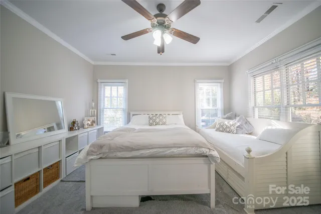 a spacious bedroom with a bed and window