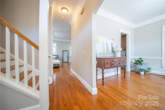 a view of a hallway view with wooden floor and furniture