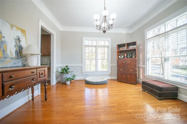 a spacious bedroom with a bed and a chandelier