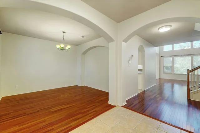 a view of an empty room and wooden floor