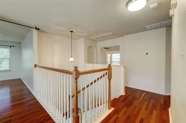 a view of a hallway with wooden floor and entryway