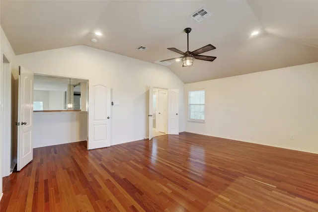 a view of empty room with wooden floor