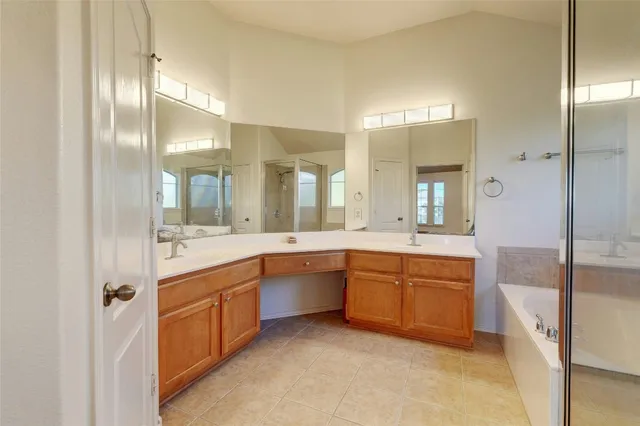 a large bathroom with a large tub and sink