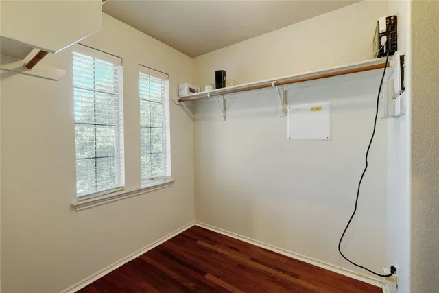 a view of a room with wooden floor and windows