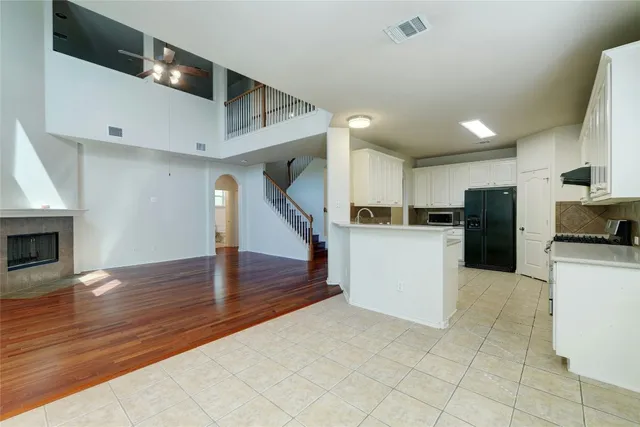 a view of a kitchen with furniture and an empty room