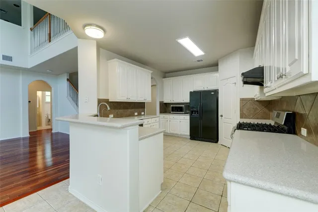 a kitchen with a refrigerator and a sink