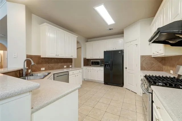 a kitchen with a sink a stove and refrigerator