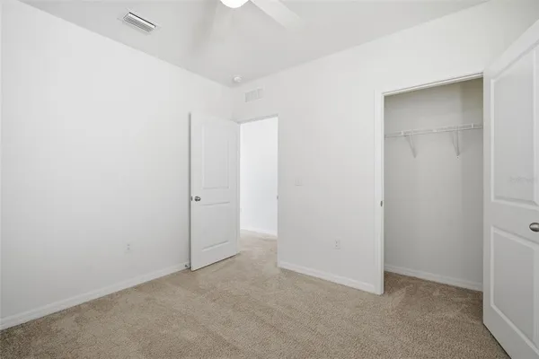 an empty room with windows and closet