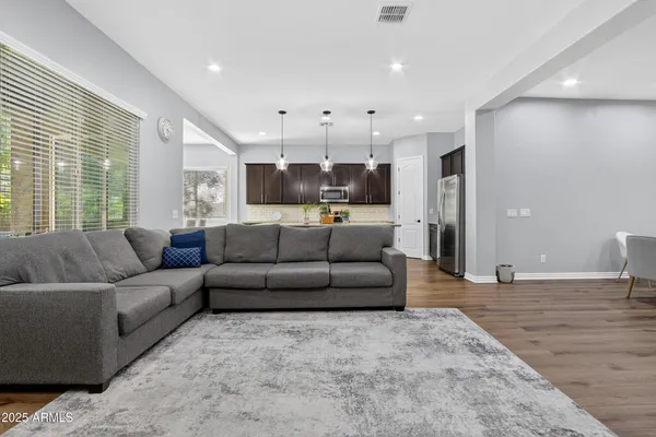 a living room with furniture and kitchen view