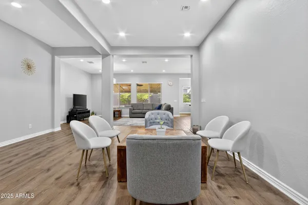 a living room with furniture and a wooden floor
