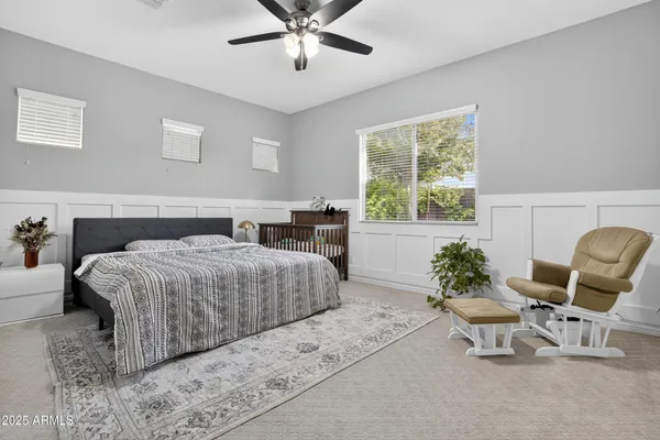 a bedroom with a bed and a chair