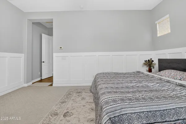 a bedroom with a bed and hallway