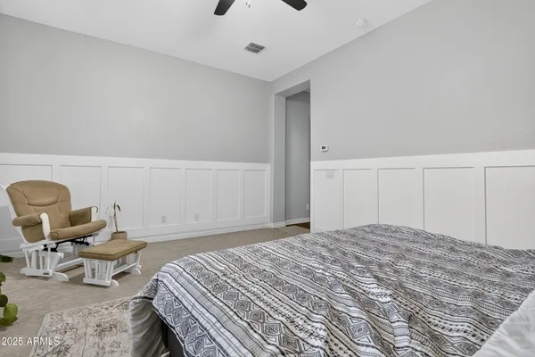 a bedroom with a bed and a chair