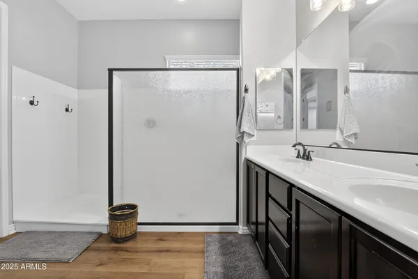 a bathroom with a double vanity sink and a mirror