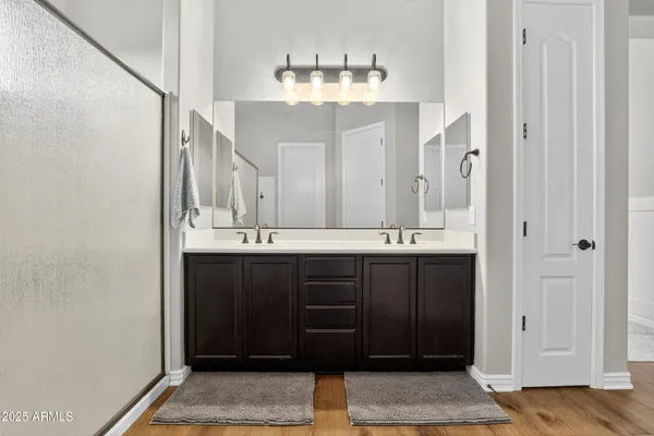 a bathroom with a double vanity sink and a mirror