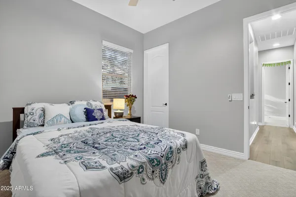 a bedroom with a large bed and a couch