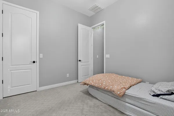 a bedroom with a bed and pillows