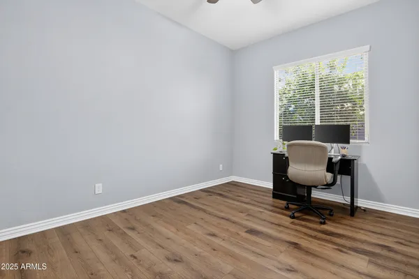a view of workspace with wooden floor and windows