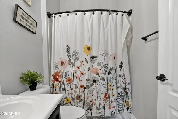 a bathroom with a shower curtain and a sink